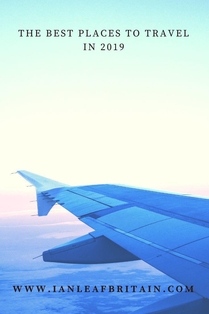 Airplane wing over clouds, with the headline 'The Best Places to Travel in 2019'